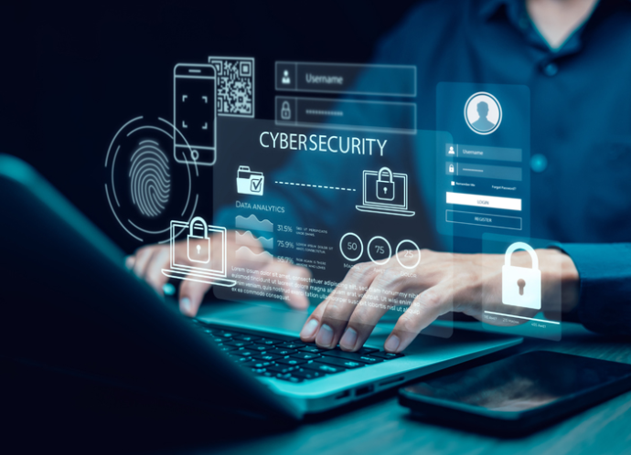 Person typing on a laptop with a cybersecurity login screen, padlocks and a fingerprint scan floating above it
